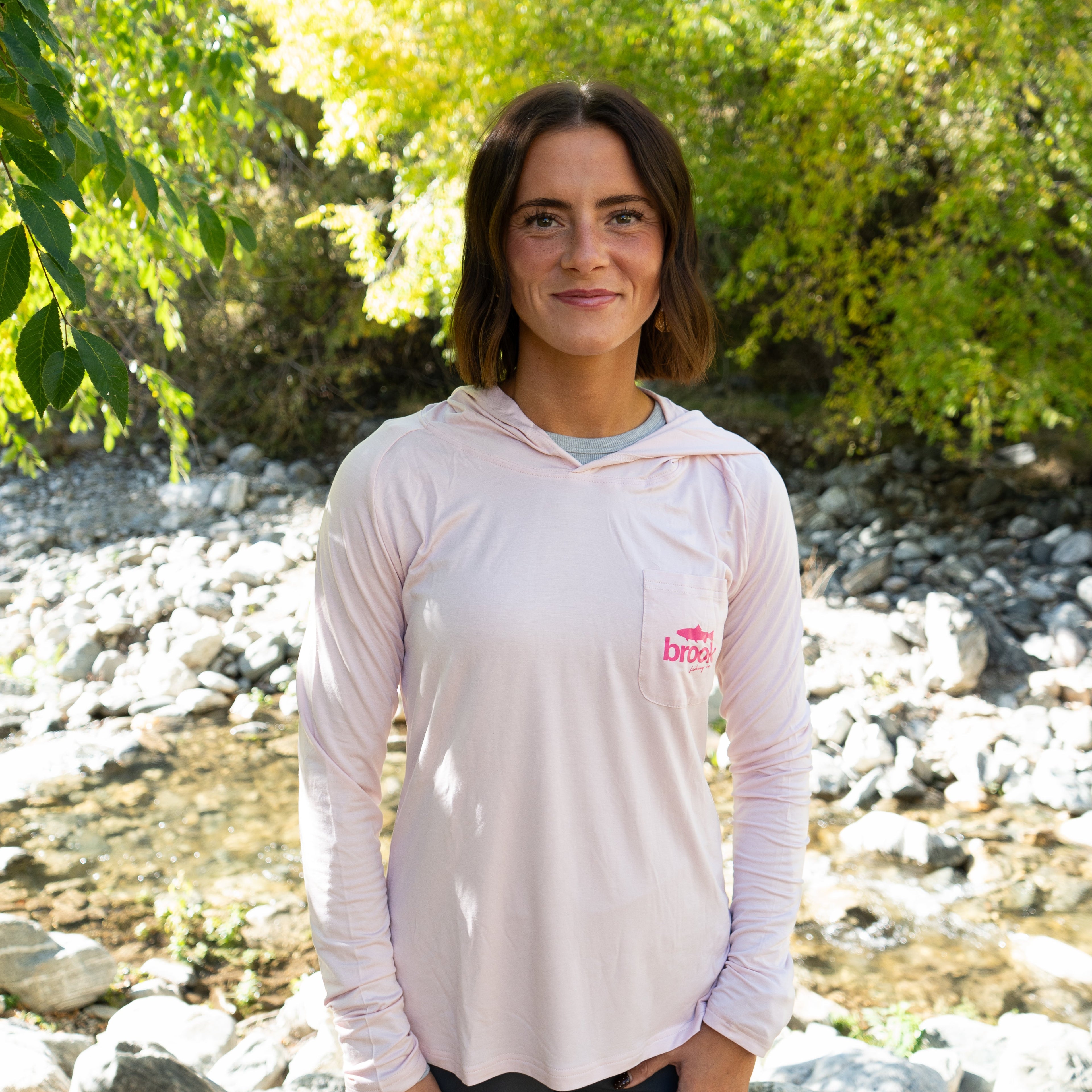 Women’s light pink bamboo sun hoodie designed for fly fishing, hiking, and sunny outdoor days with UPF 50+ protection.