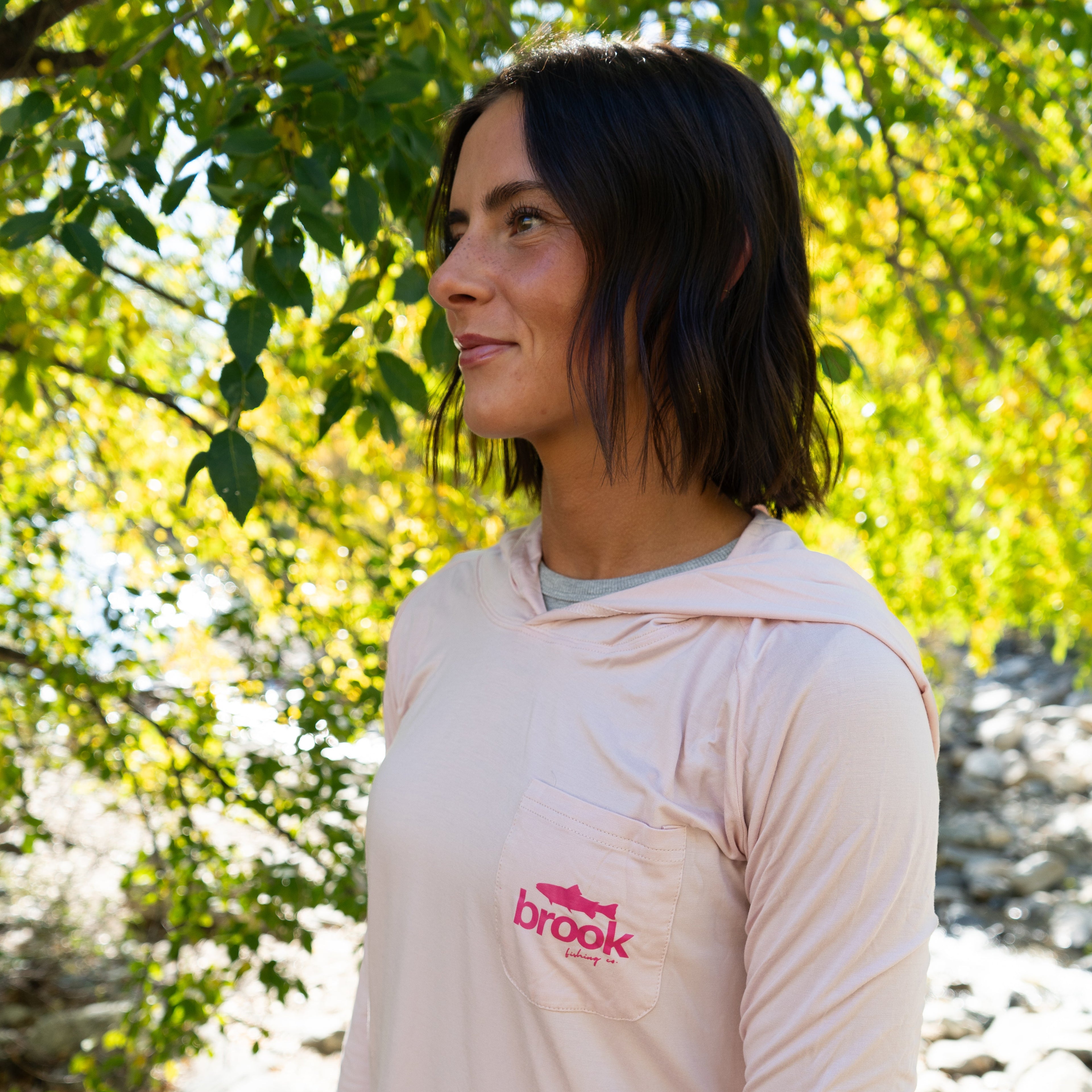 Pink Fishing Bamboo Sun Hoodie on a female fisher highlighting eco-friendly recycled materials.