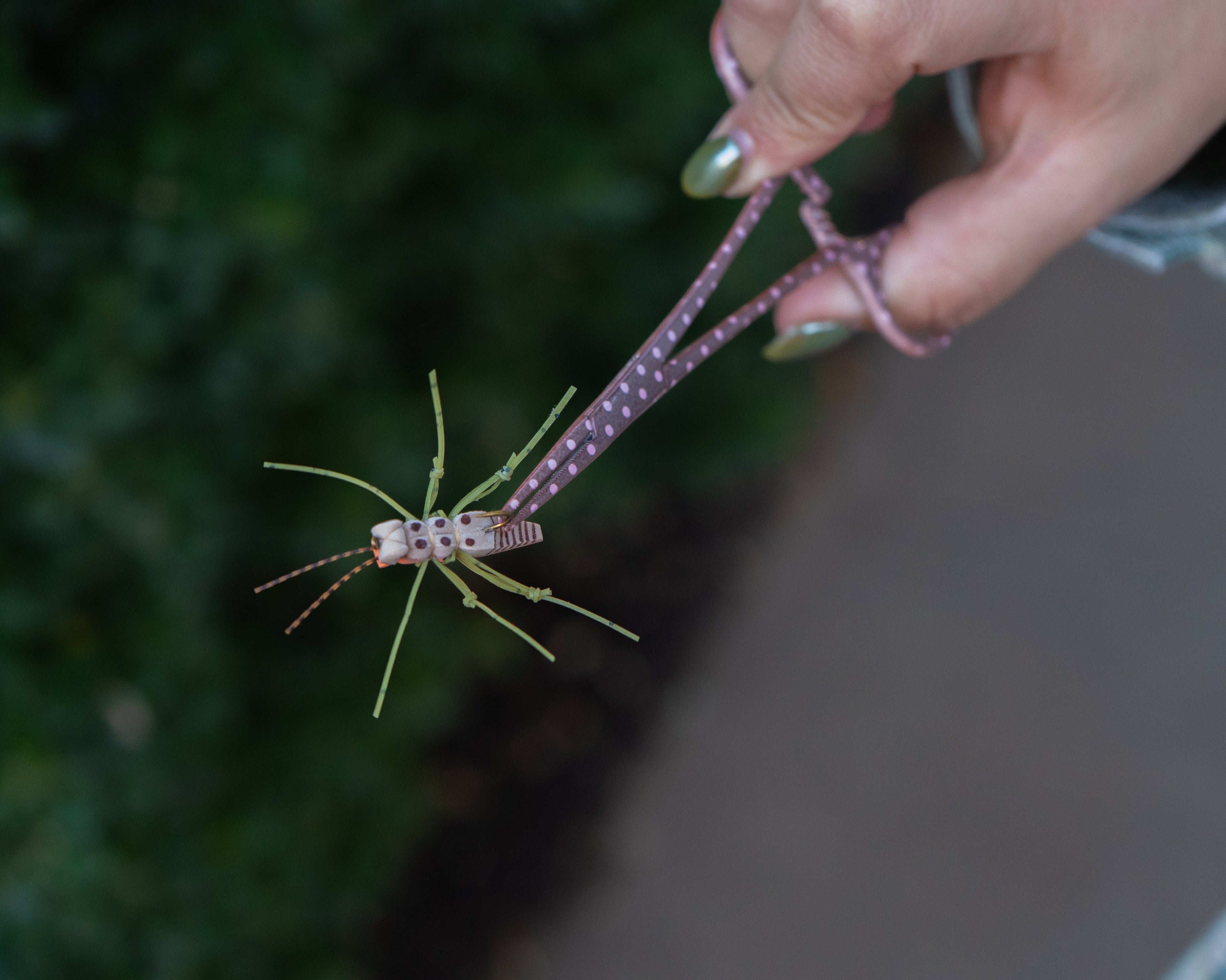 Medical-grade stainless steel fishing pliers with brown and pink pattern, designed for women anglers.