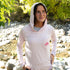 Woman fly fishing in a light pink bamboo sun hoodie with UPF 50+ protection and relaxed fit.