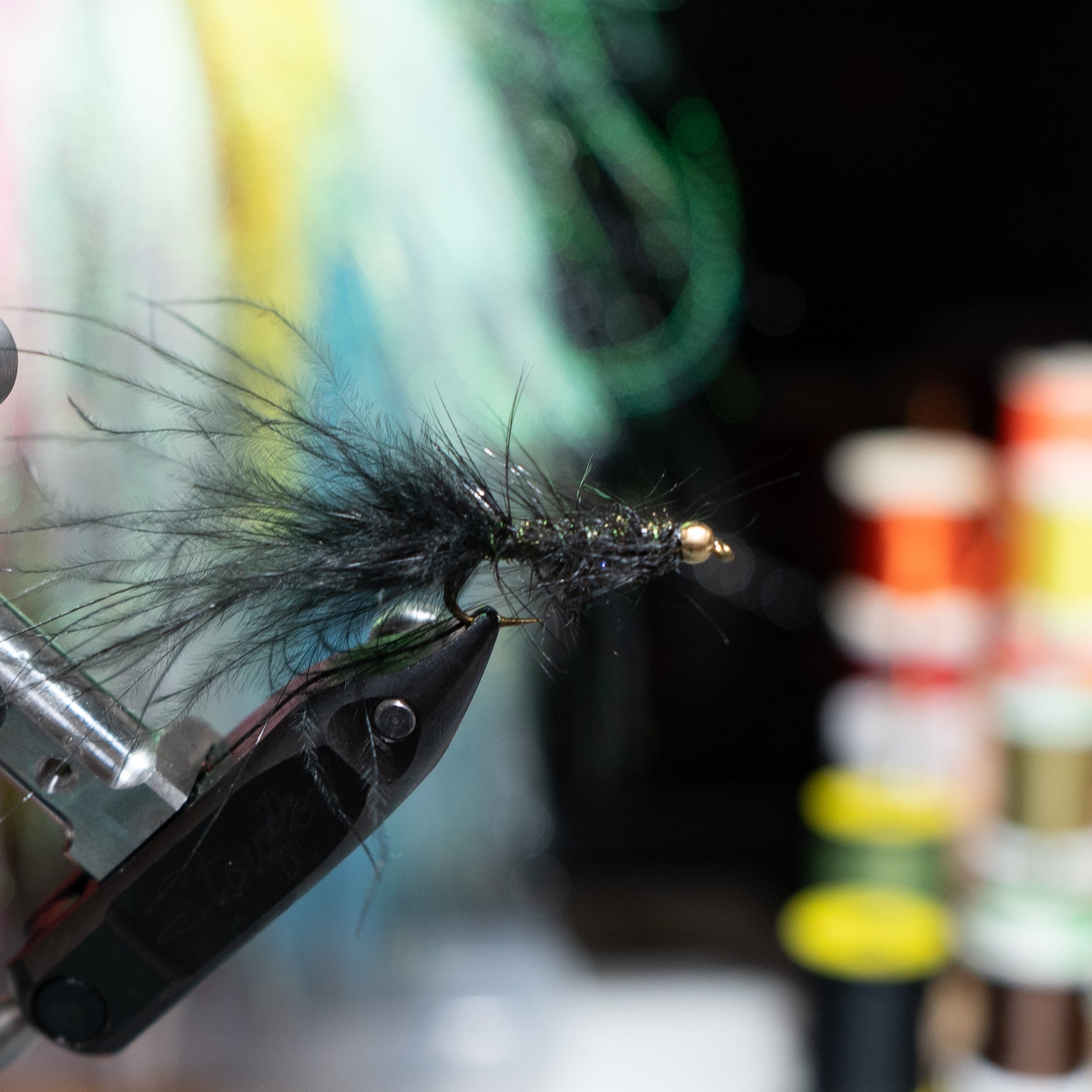 Hand-tied size 6 Wooly Bugger streamer with premium materials and a tungsten bead, designed for aggressive trout.