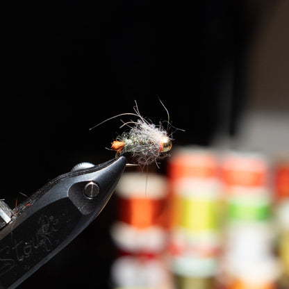 Hand-tied size 14 Blow Torch nymph with a tungsten bead, designed to attract trout in a wide range of water conditions.