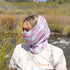 Person wearing a branded neck gaiter in a natural setting