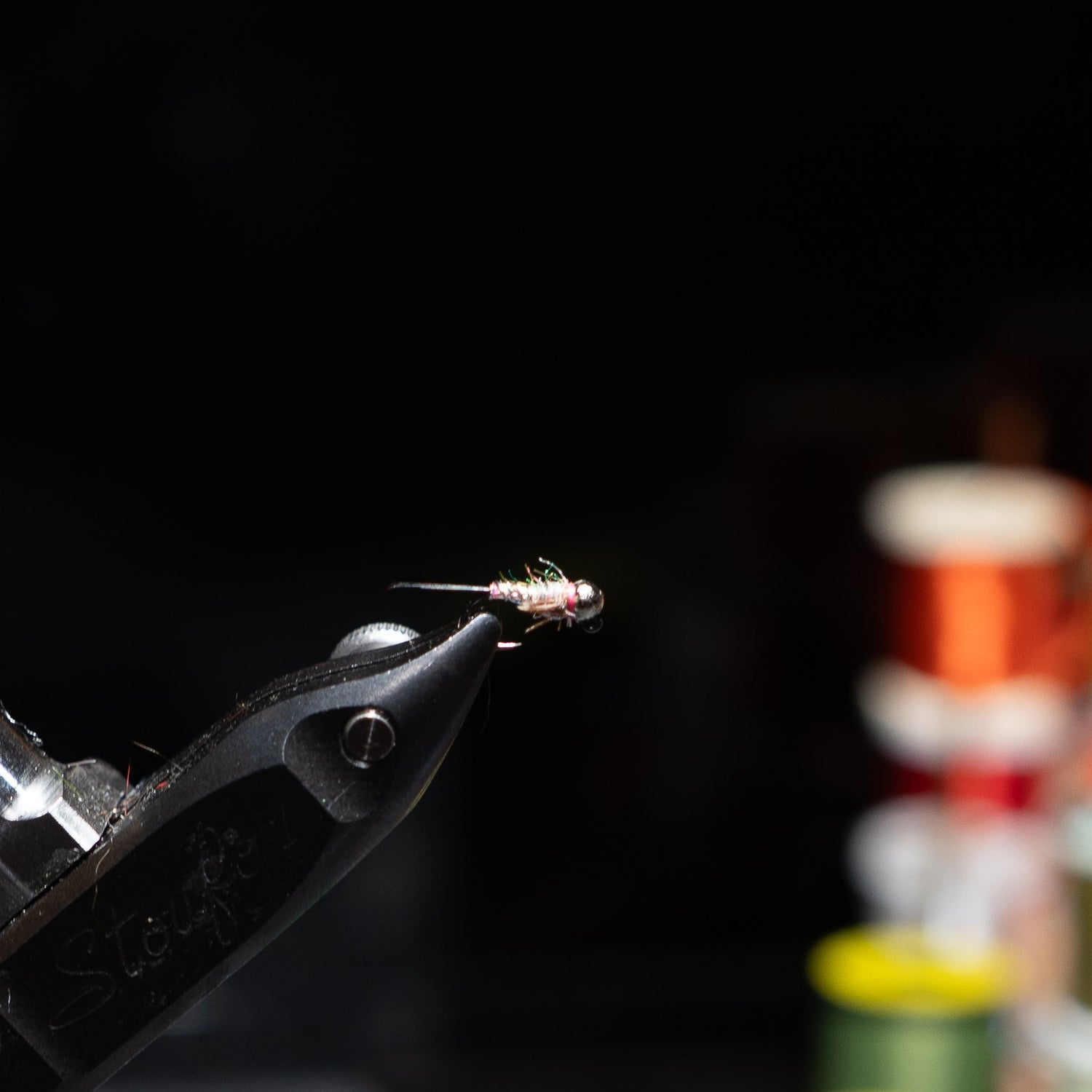 Hand-tied size 16 French jig nymph with a tungsten bead and jig hook for snag-resistant trout fishing.
