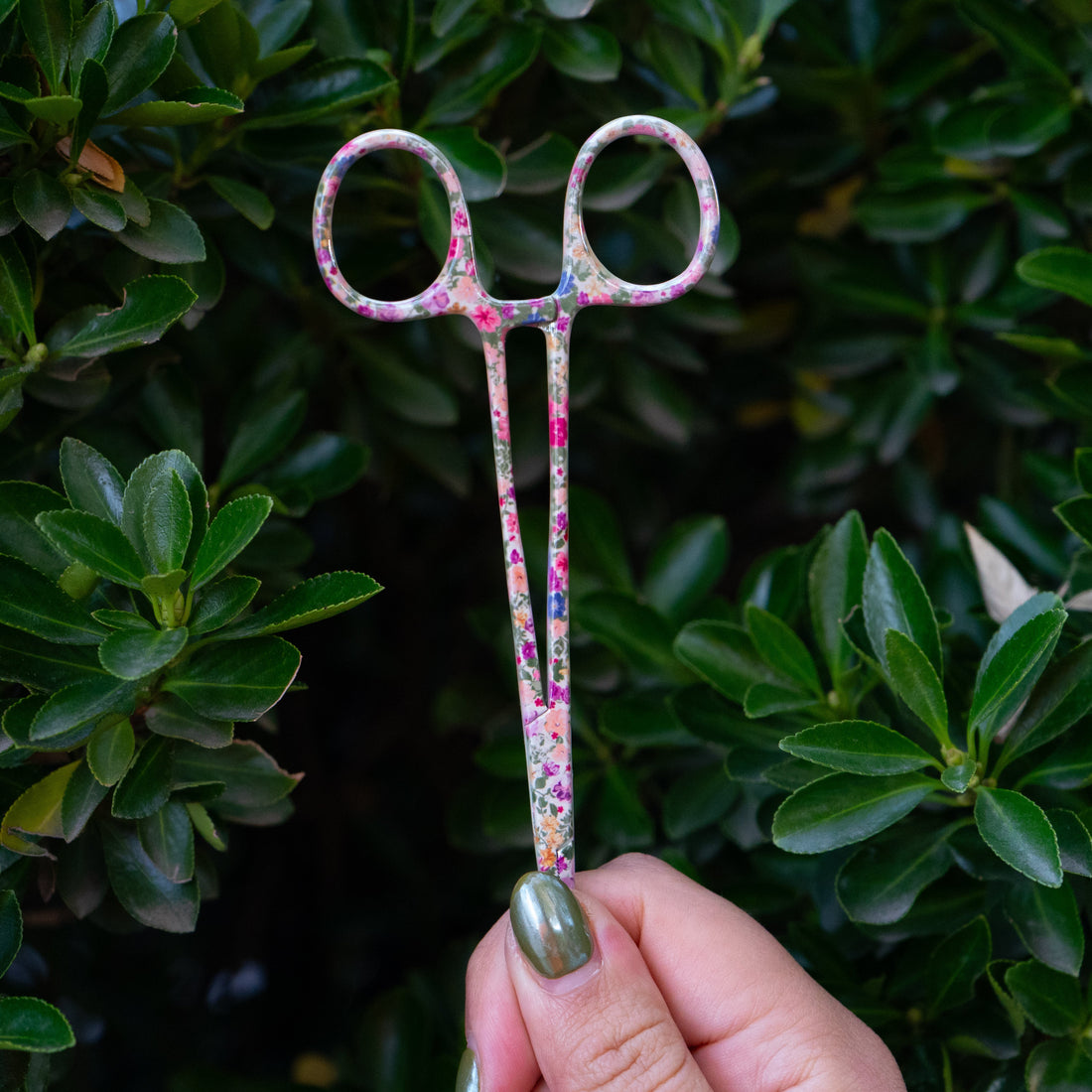 Angler holding Brook Floral Hemostats, showing size and grip for easy hook removal during fly fishing.