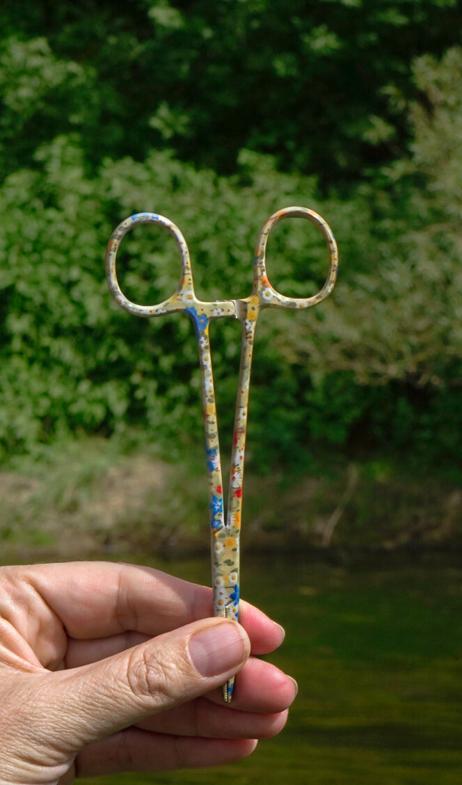 Meadow Fly Fishing Hemostats featuring a colorful wildflower and daisy-inspired pattern. A functional fishing forceps tool for removing hooks, pinching barbs, and handling flies.