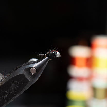 Hand-tied size 18 SOS nymph with a tungsten bead and slim profile for selective trout.